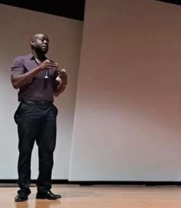 Brandon Carter speaking on stage